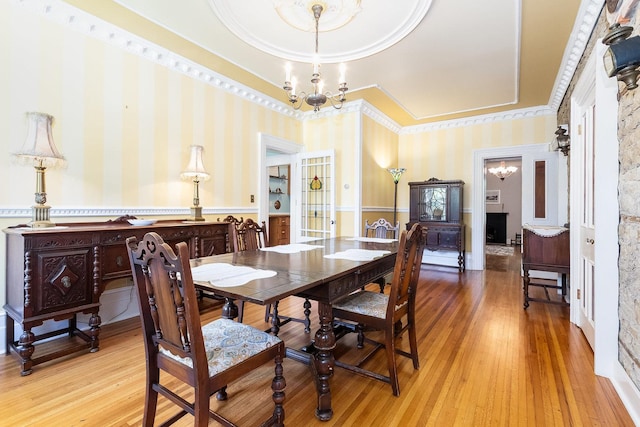 1006 S Jefferson St, Lockport, IL 60441 - dining room featuring a chandelier, a tray ceiling, hardwood / wood-style floors, ornamental molding, and wallpapered walls