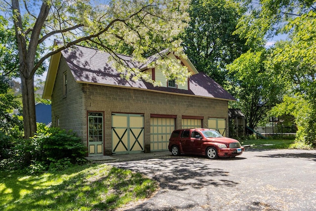 1006 S Jefferson St, Lockport, IL 60441 - view of side of home featuring driveway, roof with shingles, and a garage