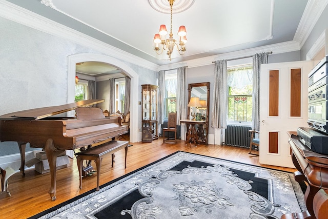 1006 S Jefferson St, Lockport, IL 60441 - living area with radiator, wood finished floors, a chandelier, crown molding, and a tray ceiling