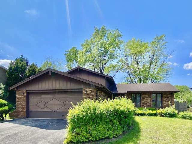 22962 Bruce Dr, Richton Park, IL 60471 - view of front facade featuring brick siding, a garage, driveway, and a front lawn