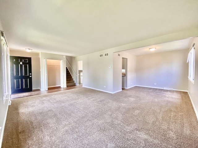 22962 Bruce Dr, Richton Park, IL 60471 - unfurnished living room with carpet, stairs, and baseboards