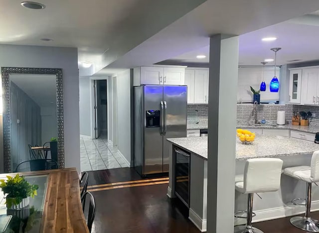 4148 S King Dr Unit G3, Chicago, IL 60653 - kitchen featuring stainless steel refrigerator with ice dispenser, beverage cooler, a sink, white cabinets, and recessed lighting