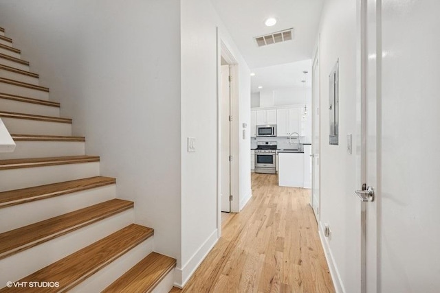 2505 W Potomac Ave Unit 3W, Chicago, IL 60622 - corridor with light wood-style floors, stairway, recessed lighting, and a sink