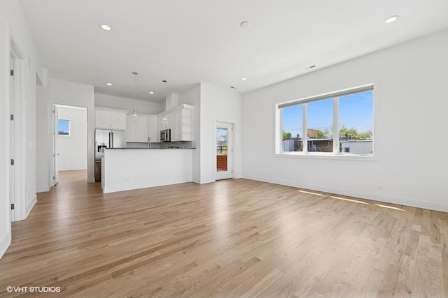 2505 W Potomac Ave Unit 3W, Chicago, IL 60622 - unfurnished living room featuring light wood finished floors, recessed lighting, and baseboards