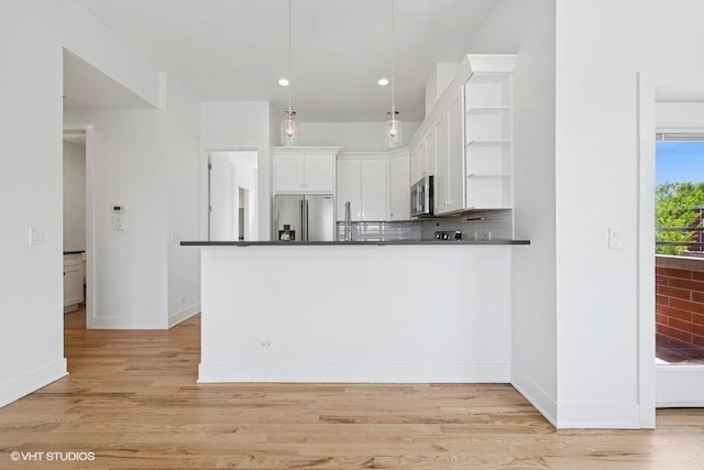 2505 W Potomac Ave Unit 3W, Chicago, IL 60622 - kitchen with appliances with stainless steel finishes, dark countertops, open shelves, white cabinetry, and light wood-type flooring