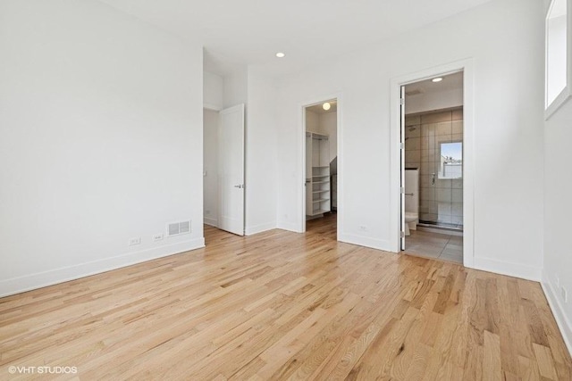 2505 W Potomac Ave Unit 3W, Chicago, IL 60622 - unfurnished bedroom featuring a walk in closet, light wood finished floors, baseboards, recessed lighting, and a closet