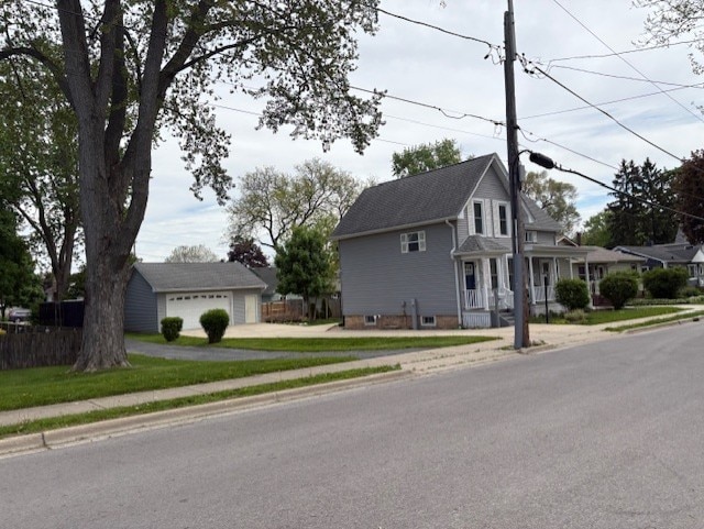 43 N Green St, Carpentersville, IL 60110 - view of front of house featuring an outbuilding, a detached garage, and driveway
