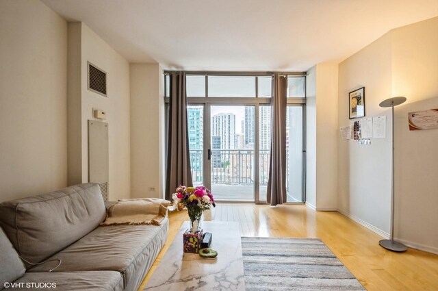 600 N Dearborn St Unit 1307, Chicago, IL 60654 - living area featuring light wood-style flooring, baseboards, and a wall of windows