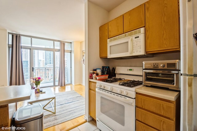 600 N Dearborn St Unit 1307, Chicago, IL 60654 - kitchen featuring white appliances, plenty of natural light, light countertops, and light wood-type flooring