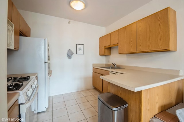 600 N Dearborn St Unit 1307, Chicago, IL 60654 - kitchen featuring white appliances, a sink, a peninsula, light countertops, and a kitchen breakfast bar