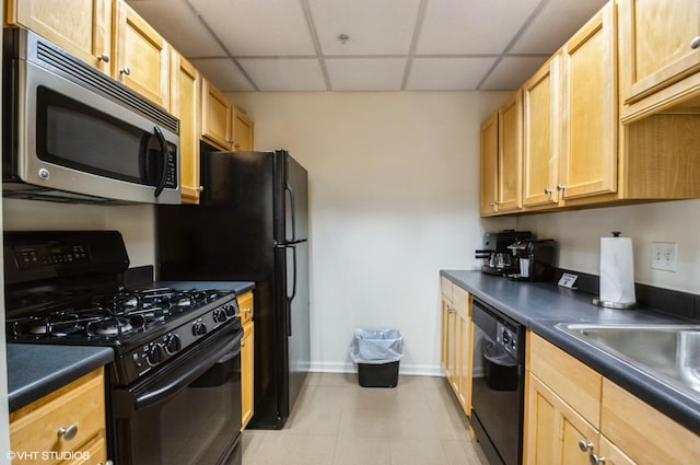 600 N Dearborn St Unit 1307, Chicago, IL 60654 - kitchen with black appliances, dark countertops, a paneled ceiling, baseboards, and light tile patterned floors