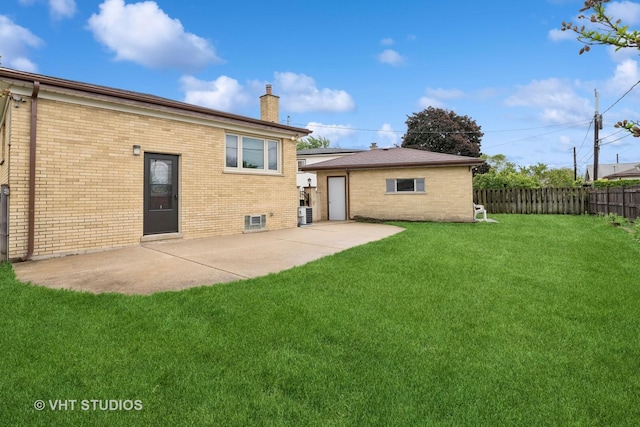 3838 Emerson Dr, Schiller Park, IL 60176 - back of property with a chimney, brick siding, a patio, and cooling unit