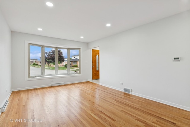 3838 Emerson Dr, Schiller Park, IL 60176 - spare room with baseboards, a baseboard radiator, light wood-style floors, and recessed lighting