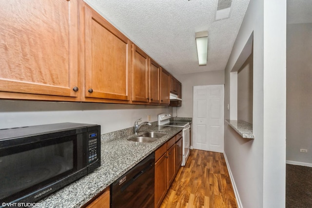2028 N Rand Rd Unit 202, Palatine, IL 60074 - kitchen with black appliances, a sink, wood finished floors, light stone counters, and brown cabinets