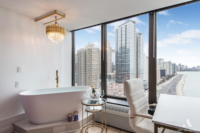 505 N Lake Shore Dr Unit 2017, Chicago, IL 60611 - dining space with a skyline view, a wall of windows, wood finished floors, a chandelier, and a water view