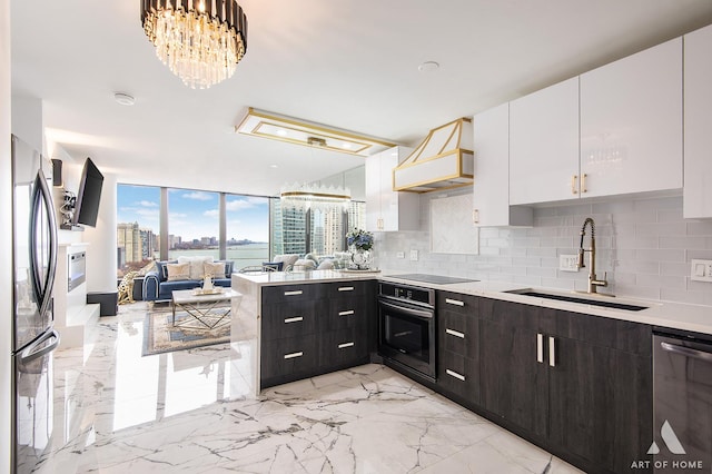 505 N Lake Shore Dr Unit 2017, Chicago, IL 60611 - kitchen featuring appliances with stainless steel finishes, a sink, premium range hood, white cabinets, and open floor plan