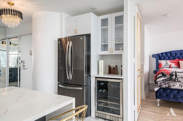 505 N Lake Shore Dr Unit 2017, Chicago, IL 60611 - kitchen with wine cooler, freestanding refrigerator, white cabinetry, glass insert cabinets, and light wood-style flooring