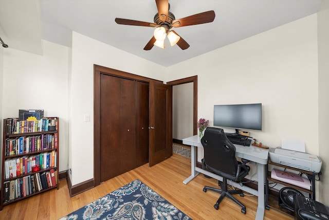 office with a ceiling fan, light wood-type flooring, and baseboards