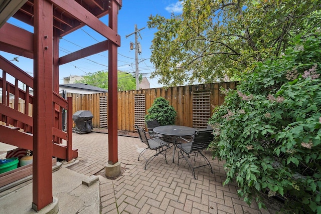view of patio / terrace with grilling area, stairway, and outdoor dining area