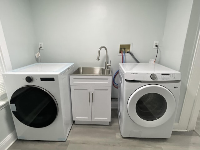 1636 N Central Ave, Chicago, IL 60639 - laundry room with cabinet space, washing machine and clothes dryer, and light wood finished floors
