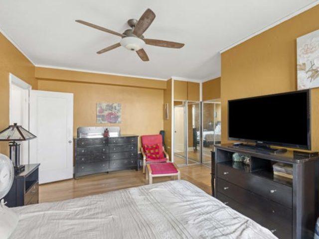 7321 S S Shore Dr Unit 11-B, Chicago, IL 60649 - bedroom with wood finished floors, ceiling fan, and ornamental molding