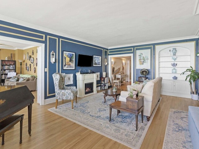 7321 S S Shore Dr Unit 11-B, Chicago, IL 60649 - living area featuring ornamental molding, light wood finished floors, and a lit fireplace