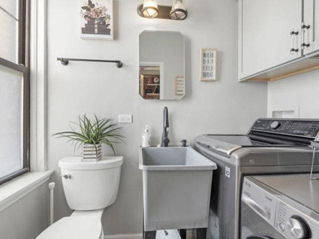 7321 S S Shore Dr Unit 11-B, Chicago, IL 60649 - washroom with washer and clothes dryer and a sink