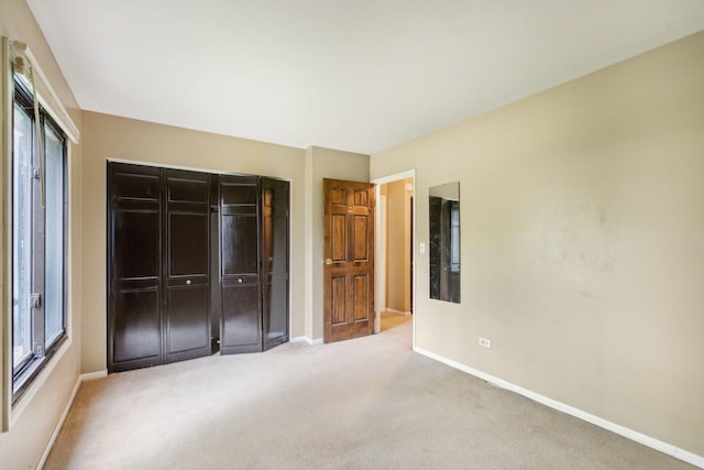 7333 Grand Ave Unit 102, Downers Grove, IL 60516 - unfurnished bedroom with a closet, baseboards, and carpet floors