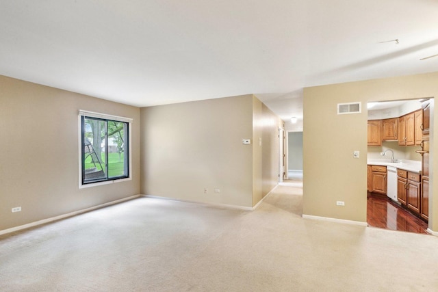 7333 Grand Ave Unit 102, Downers Grove, IL 60516 - unfurnished living room with a sink, baseboards, and carpet floors