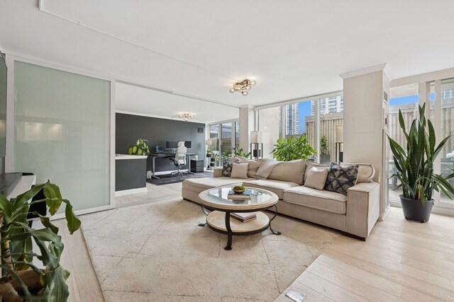 1516 N State Pkwy Unit 5D, Chicago, IL 60610 - living room featuring a desk, healthy amount of natural light, a wall of windows, and light wood-style floors