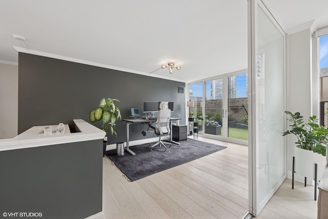 1516 N State Pkwy Unit 5D, Chicago, IL 60610 - office space with light wood-type flooring, crown molding, healthy amount of natural light, a wall of windows, and baseboards
