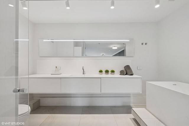 1516 N State Pkwy Unit 5D, Chicago, IL 60610 - bathroom featuring vanity, toilet, and tile patterned flooring