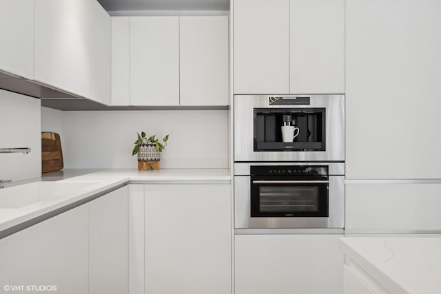 1516 N State Pkwy Unit 5D, Chicago, IL 60610 - kitchen with white cabinetry, modern cabinets, and stainless steel double oven