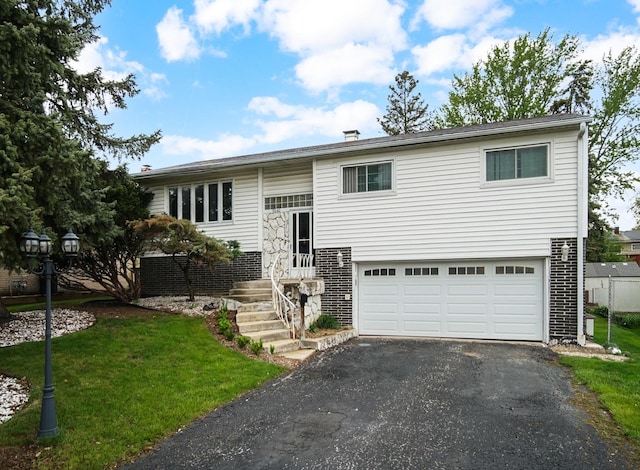 9040 Meadowview Dr, Hickory Hills, IL 60457 - split foyer home with an attached garage, asphalt driveway, brick siding, and a front yard