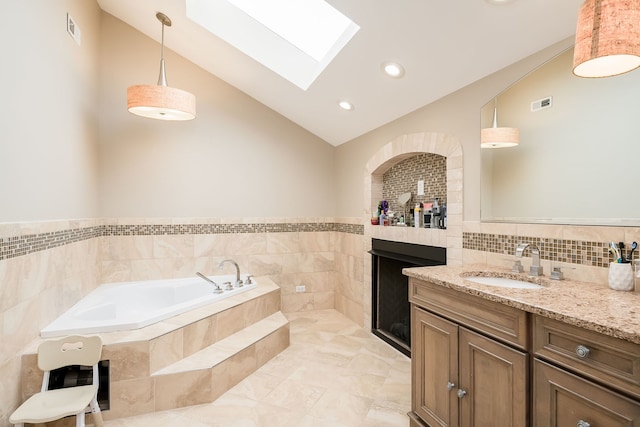 16 Lucas Dr, Palos Hills, IL 60465 - full bathroom featuring a skylight, a garden tub, vanity, tile walls, and high vaulted ceiling