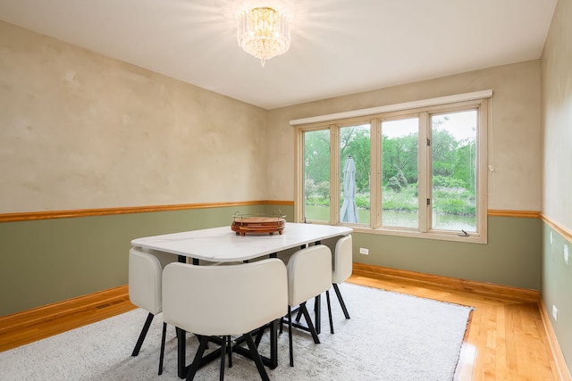 16 Lucas Dr, Palos Hills, IL 60465 - dining area featuring wood finished floors, a chandelier, and baseboards