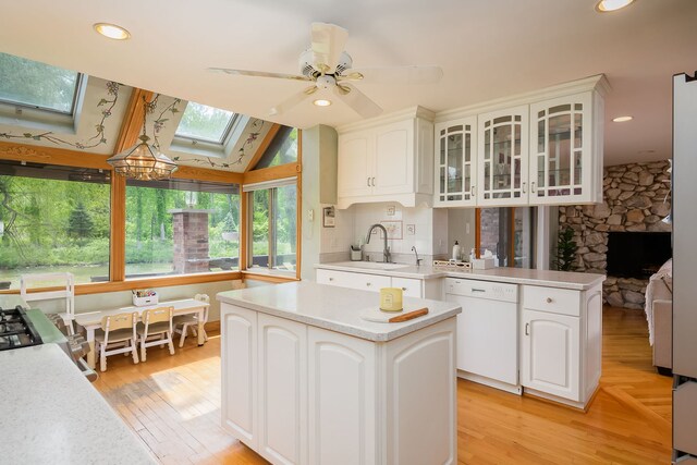16 Lucas Dr, Palos Hills, IL 60465 - kitchen featuring dishwasher, a skylight, glass insert cabinets, light countertops, and a center island