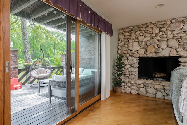 16 Lucas Dr, Palos Hills, IL 60465 - doorway with light wood finished floors and a fireplace