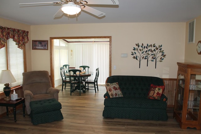 living room with ceiling fan and wood finished floors