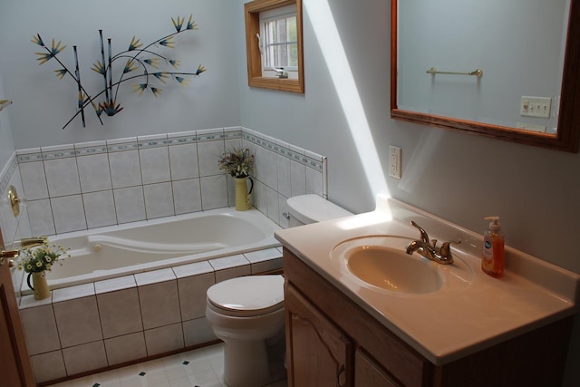 full bath featuring toilet, a garden tub, vanity, and tile patterned floors