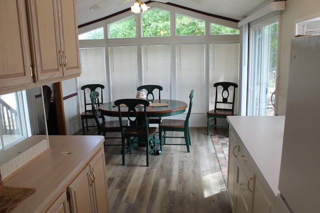 dining room featuring light wood-type flooring and lofted ceiling