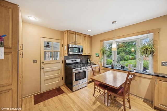 273 Desplaines Ave, Riverside, IL 60546 - kitchen with appliances with stainless steel finishes, light wood-type flooring, tasteful backsplash, hanging light fixtures, and recessed lighting