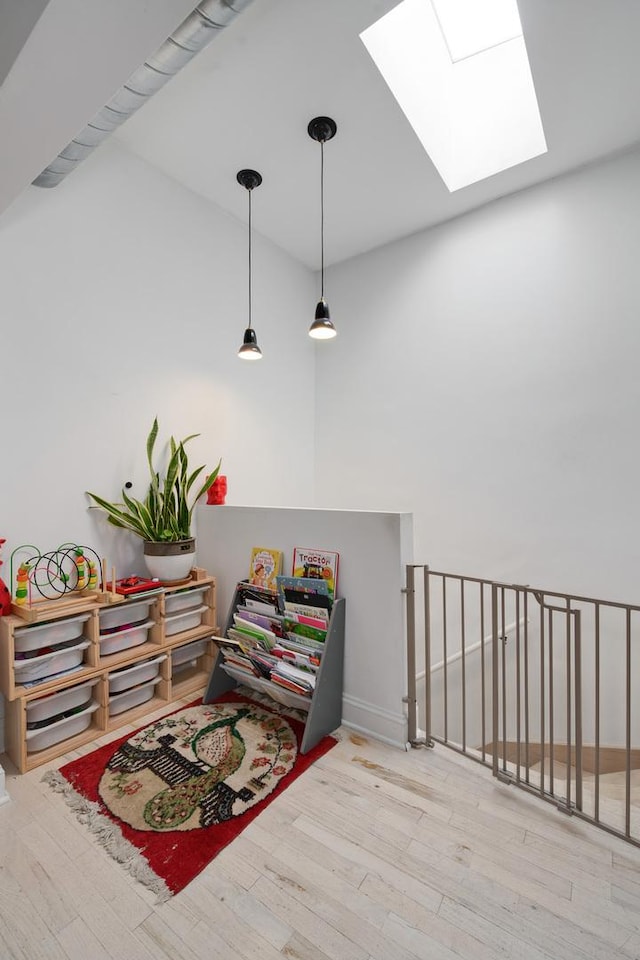 3306 W Lemoyne St, Chicago, IL 60651 - corridor with a skylight, wood finished floors, an upstairs landing, a towering ceiling, and baseboards