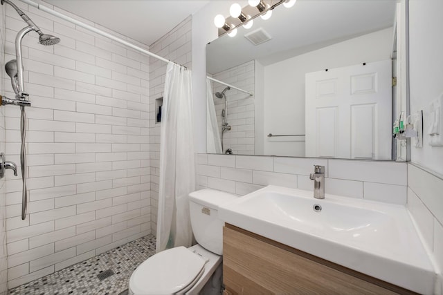 3306 W Lemoyne St, Chicago, IL 60651 - full bathroom with vanity, toilet, a tile shower, backsplash, and tile walls