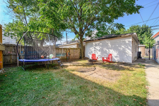 3306 W Lemoyne St, Chicago, IL 60651 - view of yard with a trampoline, a fire pit, and a gate