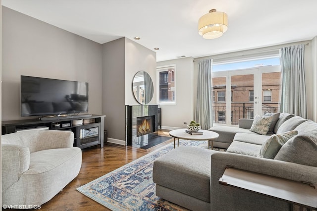2523 N Halsted St Unit 2, Chicago, IL 60614 - living area featuring dark wood-style flooring, a tile fireplace, and baseboards