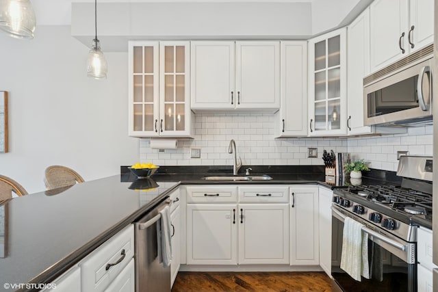 2523 N Halsted St Unit 2, Chicago, IL 60614 - kitchen featuring appliances with stainless steel finishes, a sink, dark countertops, and backsplash