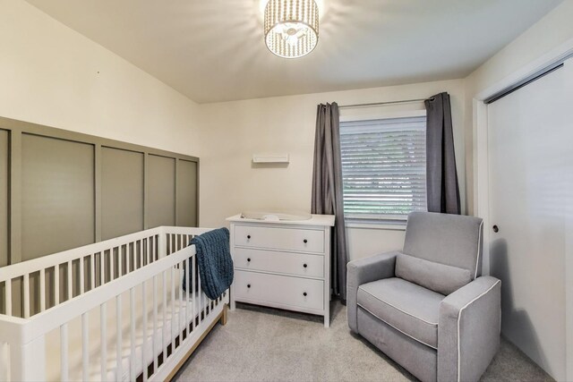 2481 Benton St, Palatine, IL 60067 - bedroom with light carpet, a chandelier, a crib, and a closet