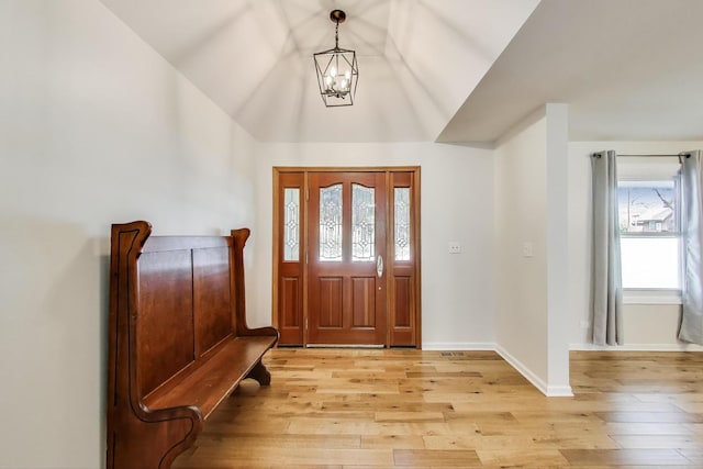 2481 Benton St, Palatine, IL 60067 - foyer entrance with a chandelier, light wood-style floors, lofted ceiling, and baseboards