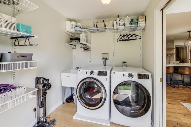 2481 Benton St, Palatine, IL 60067 - laundry room with light wood-style floors, washing machine and dryer, and baseboards